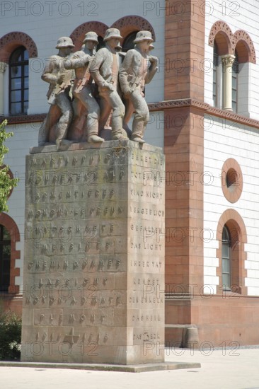 War memorial with four soldier figures and inscription, sculptures, text, Fruchthalle, Kaiserslautern, Rhineland-Palatinate, Germany