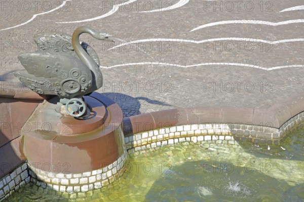Castle fountain with swan figure with detail and reliefs by Gernot Rumpf 1984, water jet, bronze sculpture, modern art, water basin, fountain, swan neck, Schlossplatz, Pirmasens, Rhineland-Palatinate, Germany