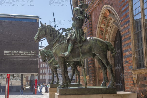 Heralds, equestrian statue at the east portal of the Old Town Hall, armoured rider with lance and helmet made of sheet copper, sculptor Rudolf Maison, in the background State Parliament, Bremen Parliament, inscription, Old Town, Hanseatic City of Bremen, Germany