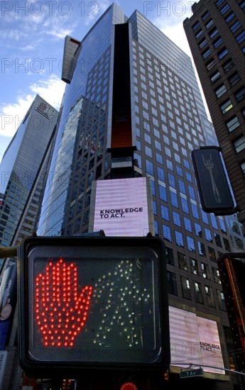 Pedestrian traffic light, skyscraper with illuminated advertising in Times Square, New York City, USA