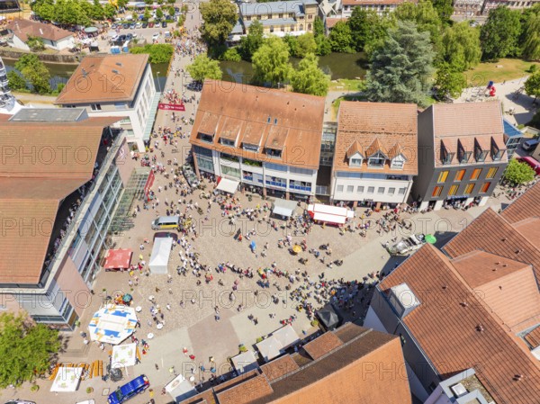 A lively, summery aerial view of a square with people, market stalls and surrounding buildings, 950 years of Calw, Calw parade, Black Forest, Germany
