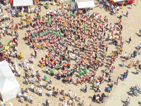 Aerial view of a festive parade on a town square with traditional costumes and a band, 950 years of Calw, Calw parade, Black Forest, Germany