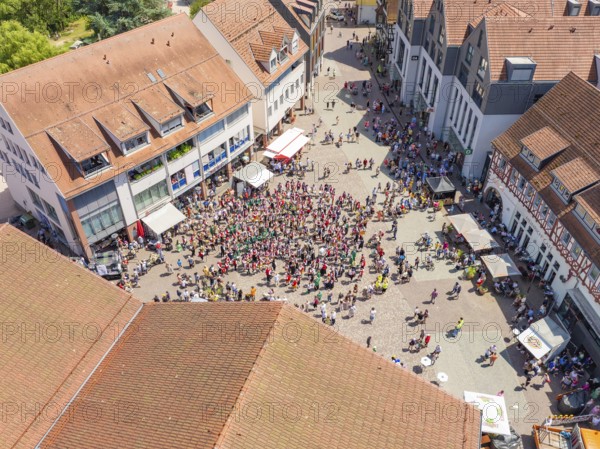 Aerial view of a large gathering on a market square in the old town centre, 950 years of Calw, Calw parade, Black Forest, Germany