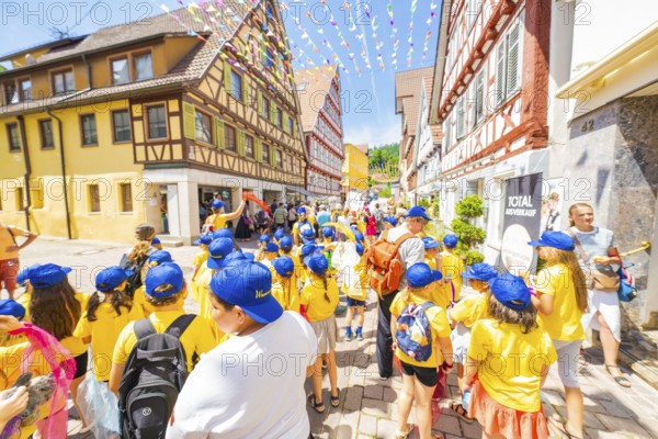 Children in yellow clothes enjoying a street party, 950 years Calw, parade Calw, Black Forest, Germany