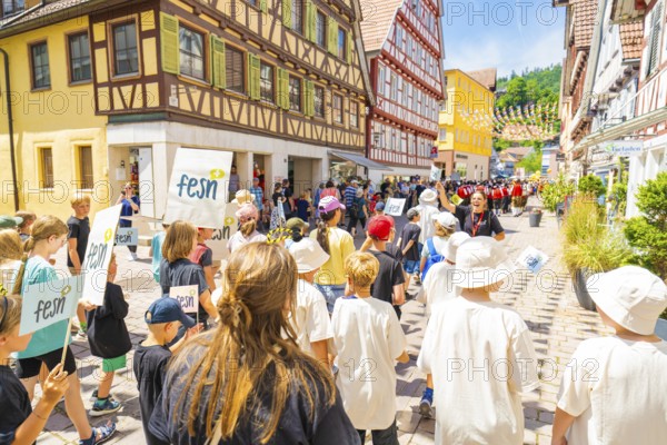 Children and adults take part in a festival in a picturesque street, 950 years of Calw, parade Calw, Black Forest, Germany