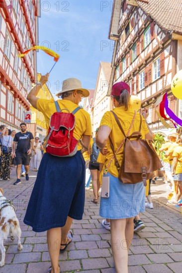Two woman with hats in a busy, festive street, 950 years Calw, parade Calw, Black Forest, Germany