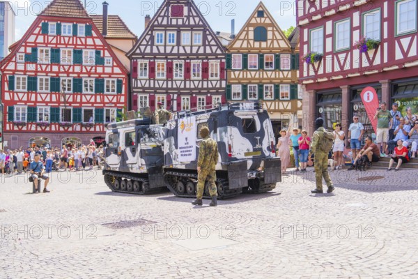 Armoured vehicles stand on a town square with half-timbered buildings and soldiers in camouflage, 950 years of Calw, Calw parade, Black Forest, Germany