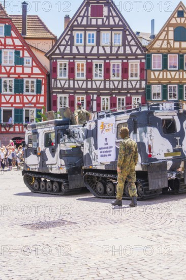 Military vehicles on a square in front of half-timbered houses, soldiers in camouflage, flowers in bloom, 950 years of Calw, Calw parade, Black Forest, Germany