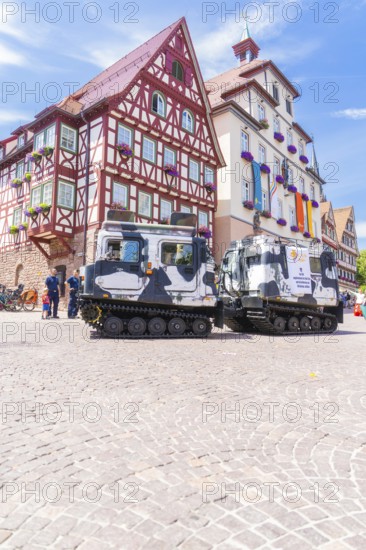 Military vehicles in front of a historic half-timbered building in a sunny old town, 950 years of Calw, Calw parade, Black Forest, Germany