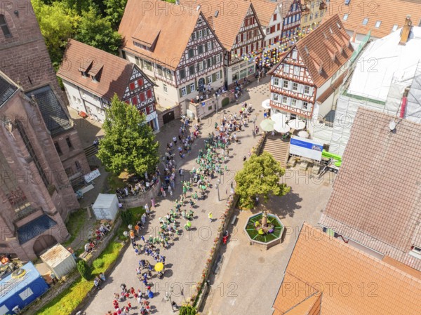 Aerial view of a street with historic houses and people enjoying a festival, 950 years of Calw, Calw parade, Black Forest, Germany