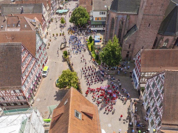 Aerial view of a lively parade through a historic town in sunny weather, 950 years of Calw, Calw parade, Black Forest, Germany