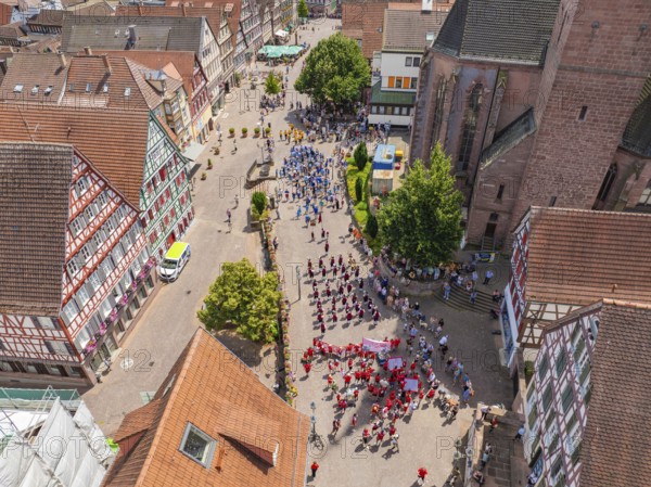 Lively town centre with people at an event, surrounded by half-timbered architecture, 950 years Calw, parade Calw, Black Forest, Germany