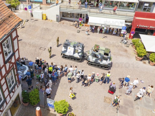 Street view with assembled spectators and military vehicles at an event, 950 years of Calw, Calw parade, Black Forest, Germany