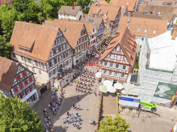 Aerial view of a town square surrounded by half-timbered houses with many people at a celebration, 950 years Calw, parade Calw, Black Forest, Germany