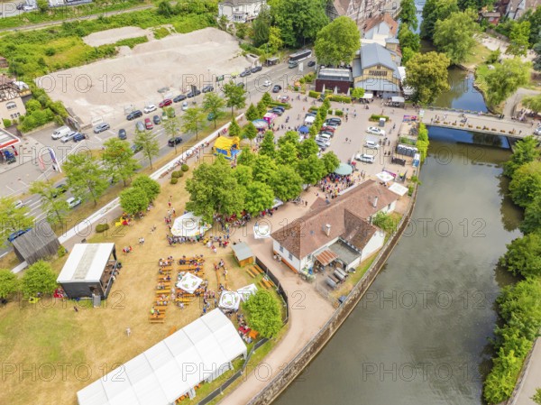View of an event with tents and facilities along a river, 950 years of Calw, Calw parade, Black Forest, Germany