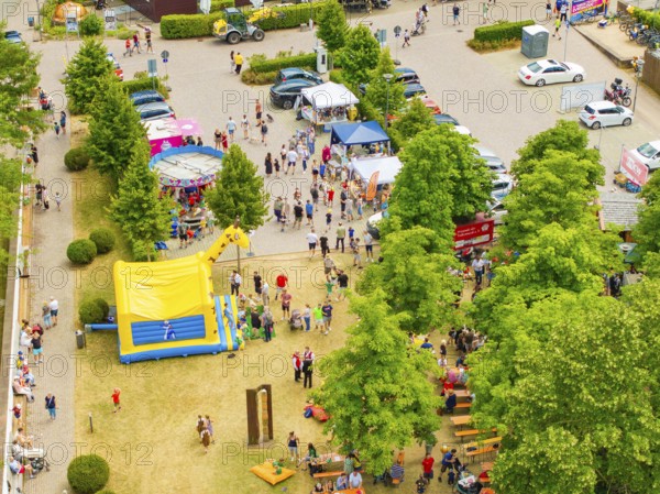 Park full of people and children's attractions with colourful tents under green trees, 950 years of Calw, Calw parade, Black Forest, Germany