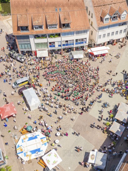 Aerial view of a square with a crowd of people and surrounding buildings, 950 years of Calw, Calw parade, Black Forest, Germany