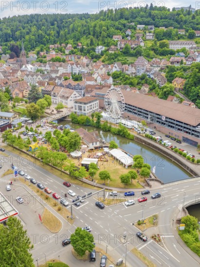 Cityscape with crossroads, cars and a large Ferris wheel along a river, 950 years of Calw, Calw parade, Black Forest, Germany