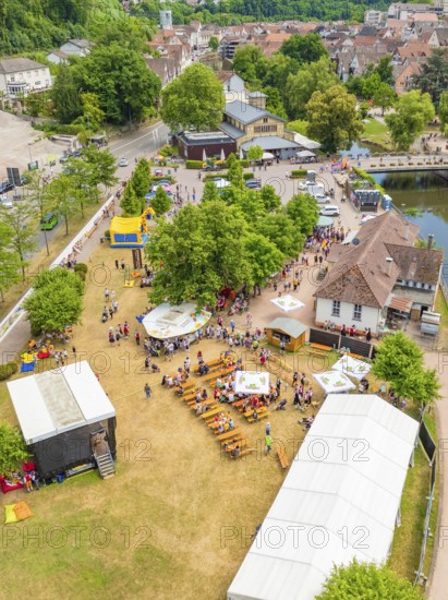 Park event with many people and tents, adjacent to a river and municipal buildings, 950 years of Calw, parade Calw, Black Forest, Germany