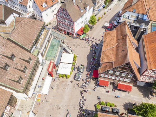 Historic buildings and crowds on a central town square, 950 years of Calw, Calw parade, Black Forest, Germany