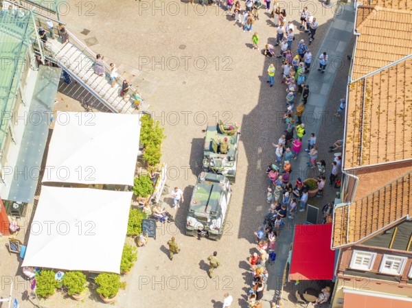 Vehicles and people on a street, lined by several buildings, 950 years Calw, parade Calw, Black Forest, Germany