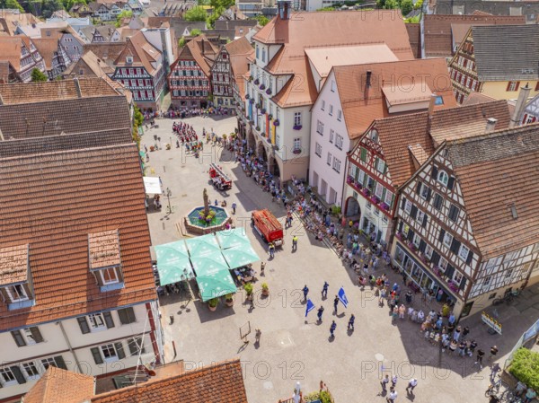 People and flags parade past on a lively market square between half-timbered houses, 950 years of Calw, Calw parade, Black Forest, Germany