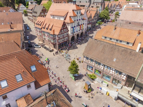 Central square in a town, surrounded by half-timbered houses and people, 950 years of Calw, Calw parade, Black Forest, Germany
