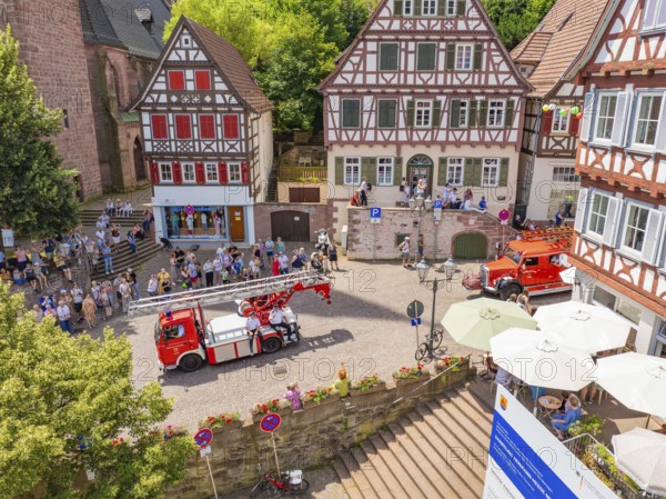 Fire engines drive through a half-timbered neighbourhood, watched by numerous spectators, 950 years of Calw, Calw parade, Black Forest, Germany
