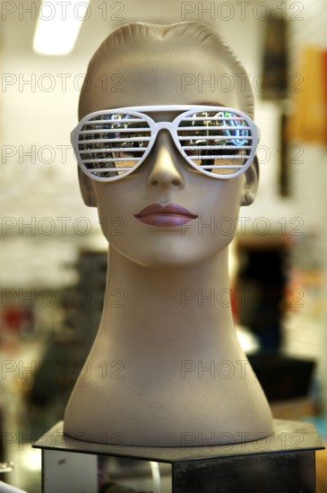 Female mannequin with sunglasses at an optician, New York City, USA