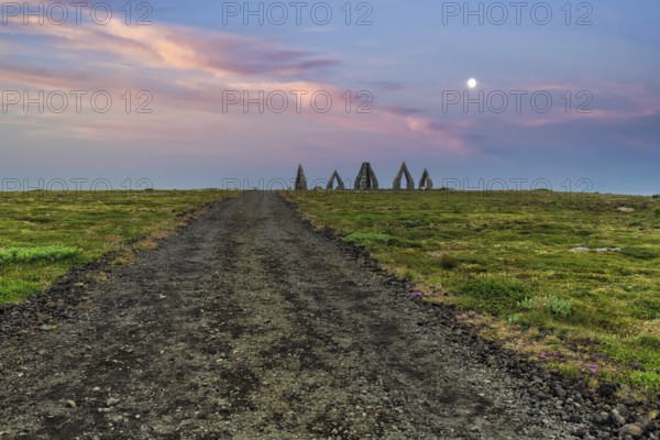 Gravel path to the Arctic Henge, large stone gates, basalt, landmark in barren landscape, Heimskautsgerði, Heimskautsgerdi, artist Erlingur Thorodsen, evening sky, Raufarhöfn, Melrakkasletta, North-East Iceland, Iceland