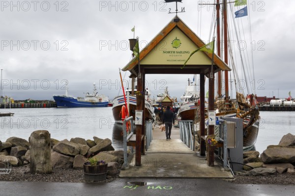 Boat dock in the harbour, fishing village at Skjalfandi Bay, rain clouds, Husavik, Húsavík, North Iceland, Iceland