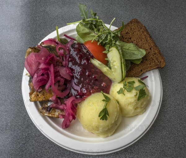 Typical Swedish meal: Fried herring with mashed potatoes, lingonberry jam, bread and vegetables