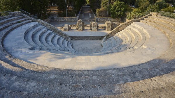 Round ancient theatre with ruined walls and stone steps surrounded by nature, Ancient Theatre, Odeon, Kos Town, Kos, Dodecanese, Greek Islands, Greece