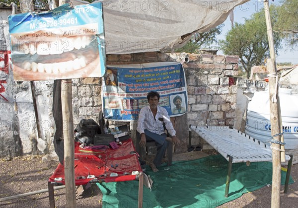 Indian man at a dentist stand in the Thar Desert or Great Indian Desert, near Jaisalmer, Rajasthan, India