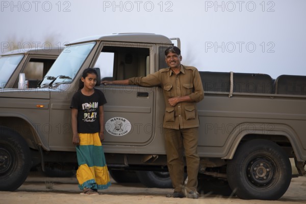 Indian man and Indian girl on a desert jeep, desert dwellers in the Thar Desert or Great Indian Desert, near Jaisalmer, Rajasthan, India