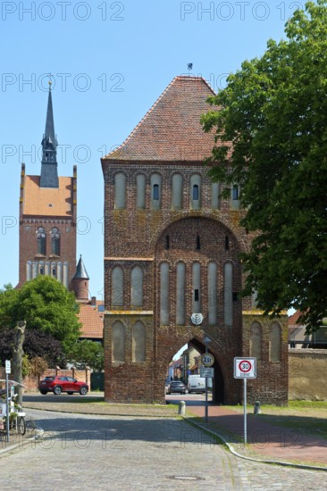 Brick building Anklamer Tor, St Mary's Protestant Church at the back, town of Usedom, island of Usedom, Mecklenburg-Western Pomerania, Germany
