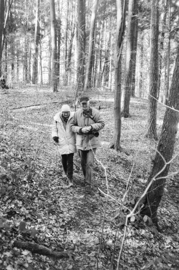 Elderly couple walking in the forest, black and white, Bavaria, Germany