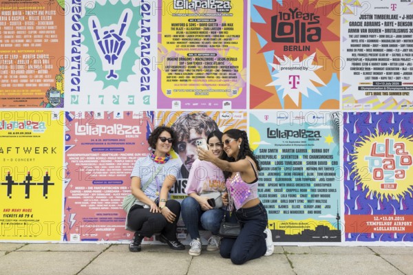 Festival visitors taking photos of themselves in front of Lollapalooza Festival posters from previous years at the Lollapalooza Festival in the Olympic Stadium and on the Maifeld, Berlin, 13.07.2025