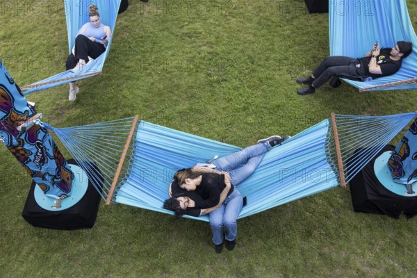 Festival visitors lying in hammocks in the Fashionpalooza at the Lollapalooza Festival in the Olympic Stadium and on the Maifeld, Berlin, 13.07.2025