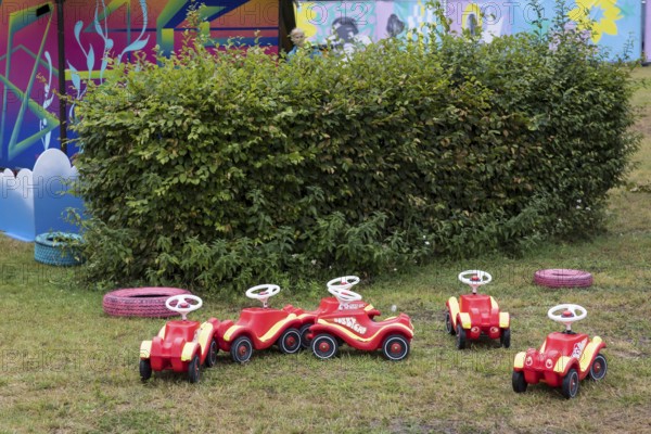 Unused bobby cars are parked in a corner of the Kidzapalooza at the Lollapalooza Festival in the Olympic Stadium and on the Maifeld, Berlin, 12.07.2025