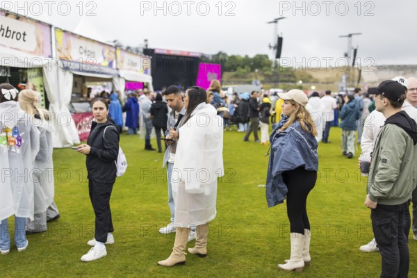 Festival visitors in front of a food stand at the Lollapalooza Festival in the Olympic Stadium and on the Maifeld, Berlin, 12 July 2025