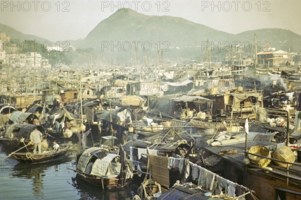 People living on sampan boats in the harbour at Aberdeen, Hong Kong, Asia 1964
