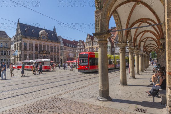 Historic market square with the Schütting House, the Chamber of Commerce and Industry (left), and the gabled houses, Town Musicians Express for tourist tours, tram, view through the arcade of the town hall, UNESCO World Heritage Site, listed building, Old Town, Hanseatic City of Bremen, Germany