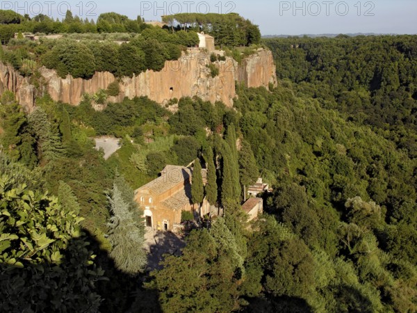 Romanesque basilica, Basilica di Sant'Elia, 8th to 9th century, Benedictine abbey, Chiesetta di San Michele Arcangelo church above, steep tufa rock face, dense forest, Valle Suppentonia gorge, Castel Sant'Elia, Viterbo province, Lazio, Italy