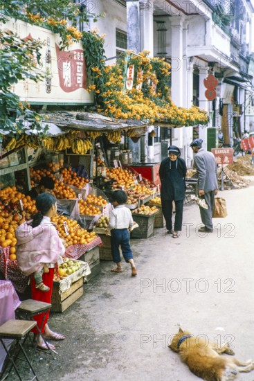 Fruit shop display of oranges and bananas on street, New Territories, Hong Kong, Asia, 1964
