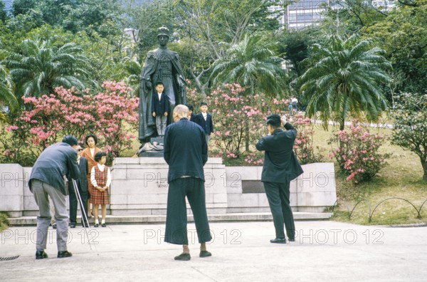 Sunday outings family photo, Mid Levels, Botanical Gardens, Hong Kong, Asia, 1964 children pose by bronze statue of King George VI