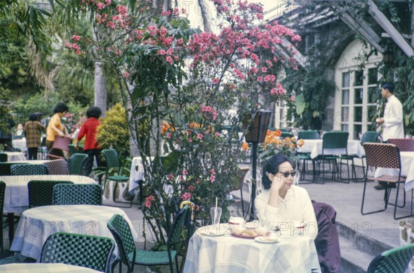 Woman sitting at table of restaurant at the Peak, Hong Kong, Asia, 1964