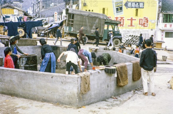 Women washing clothes in street at public laundry place, Tai Po, New Territories, Hong Kong, Asia, 1964