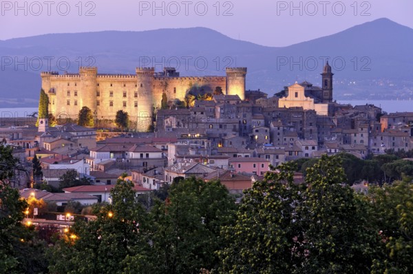 Fortress Castello Odescalchi, Duomo Santo Stefano, illuminated, blue hour, behind Bracciano Lake, Lago di Bracciano, historic centre, Bracciano, metropolitan city of Rome, Lazio, Italy