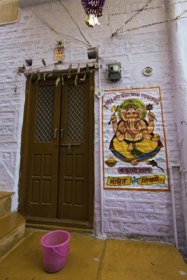 Colourful Ganesha image next to a front door in the fortress of Jaisalmer, Rajasthan, India